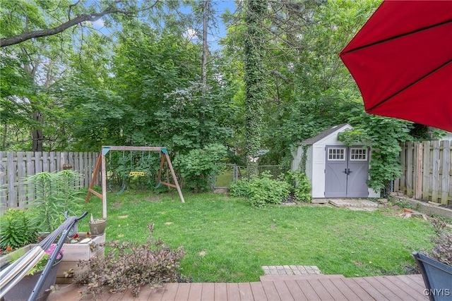135 Strong Ave, Syracuse, NY 13210 - fenced backyard with a storage shed, a deck, and a playground
