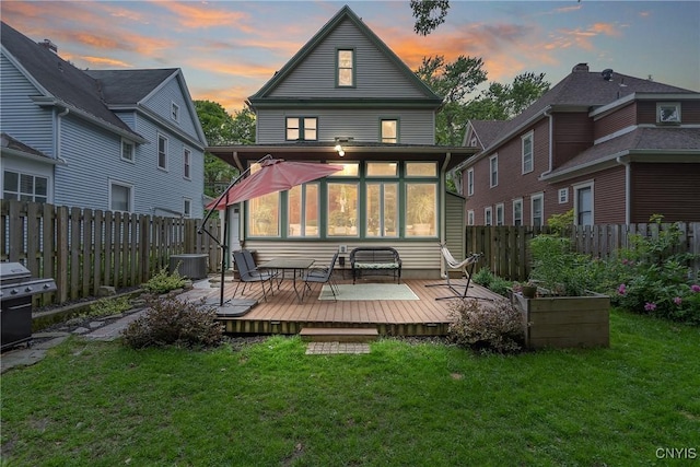 135 Strong Ave, Syracuse, NY 13210 - back of house at dusk with a wooden deck and a fenced backyard