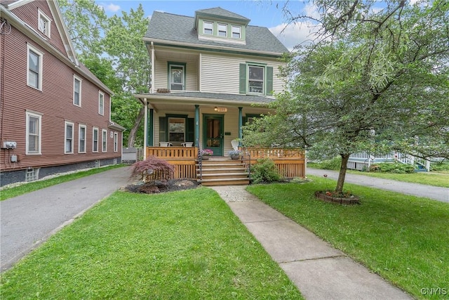 135 Strong Ave, Syracuse, NY 13210 - american foursquare style home featuring a porch, a front lawn, and roof with shingles