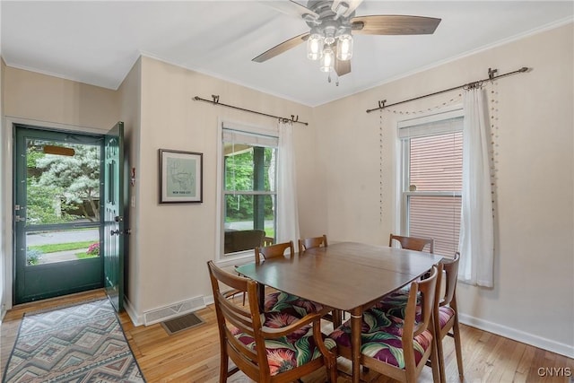 135 Strong Ave, Syracuse, NY 13210 - dining room featuring light wood finished floors, ceiling fan, and crown molding