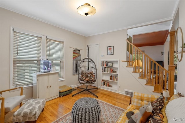 135 Strong Ave, Syracuse, NY 13210 - living area with wood finished floors, crown molding, stairway, and built in shelves