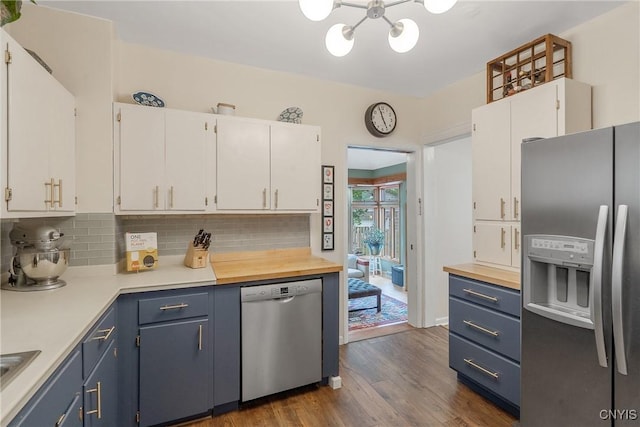 135 Strong Ave, Syracuse, NY 13210 - kitchen with appliances with stainless steel finishes, a chandelier, tasteful backsplash, white cabinetry, and blue cabinets
