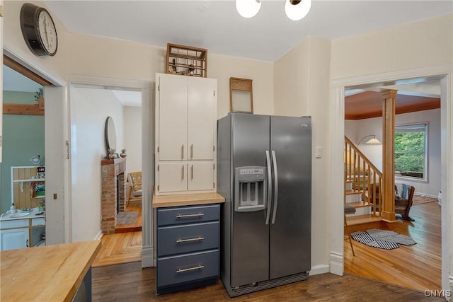 135 Strong Ave, Syracuse, NY 13210 - kitchen with stainless steel fridge with ice dispenser, butcher block countertops, decorative columns, and dark wood finished floors