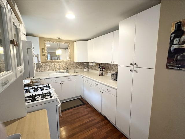 5968 E Lake Rd, Conesus, NY 14435 - kitchen featuring white range with gas stovetop, dark wood finished floors, backsplash, white cabinetry, and pendant lighting