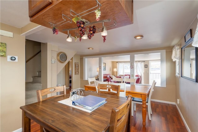 5968 E Lake Rd, Conesus, NY 14435 - dining area featuring stairs, wood finished floors, and a chandelier