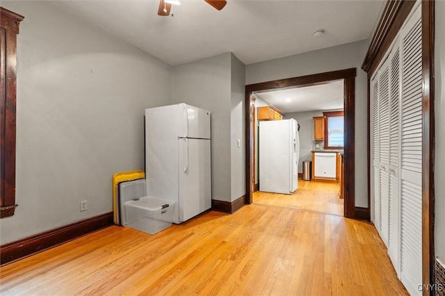 606 Tompkins St, Syracuse, NY 13204 - kitchen with white appliances, light wood-style flooring, ceiling fan, and brown cabinets