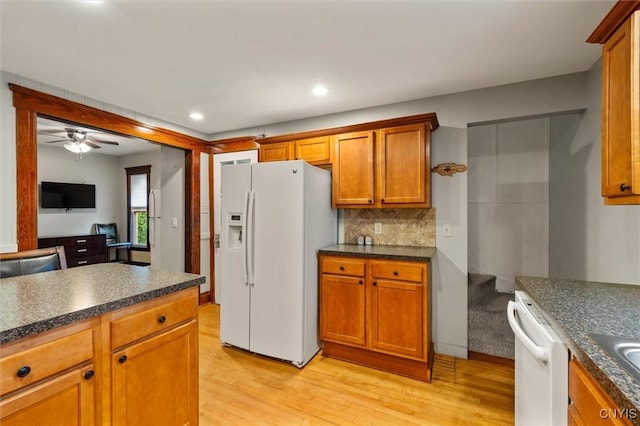 606 Tompkins St, Syracuse, NY 13204 - kitchen with white appliances, light wood-style floors, dark countertops, tasteful backsplash, and recessed lighting
