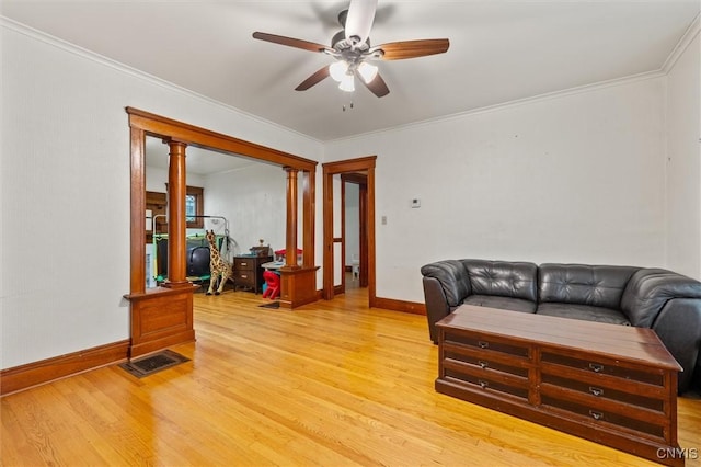 606 Tompkins St, Syracuse, NY 13204 - living room featuring light wood-style flooring, ceiling fan, ornamental molding, and ornate columns
