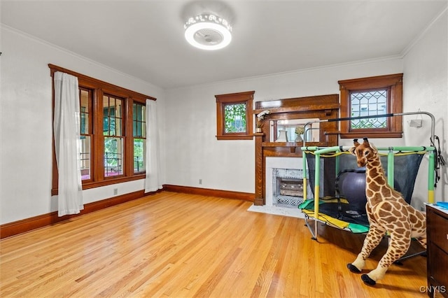 606 Tompkins St, Syracuse, NY 13204 - living room with wood finished floors, a fireplace with flush hearth, healthy amount of natural light, and ornamental molding
