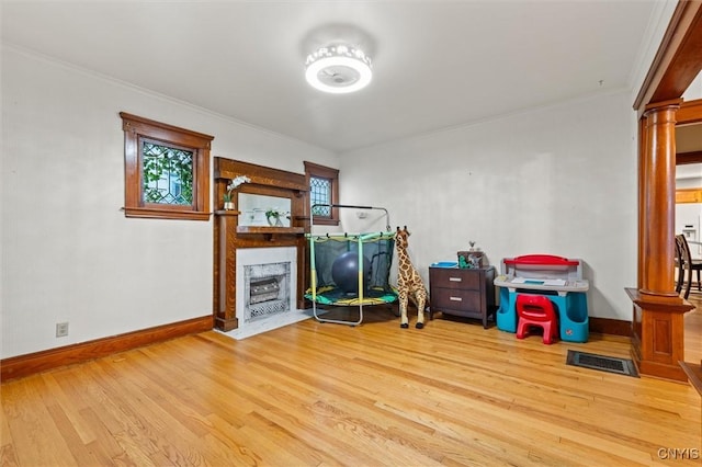 606 Tompkins St, Syracuse, NY 13204 - game room with a fireplace with flush hearth, wood finished floors, ornamental molding, and decorative columns