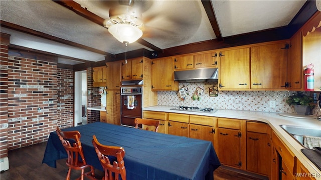 115 Southgate Rd, Cheektowaga, NY 14215 - kitchen with black oven, under cabinet range hood, a ceiling fan, gas cooktop, and beamed ceiling