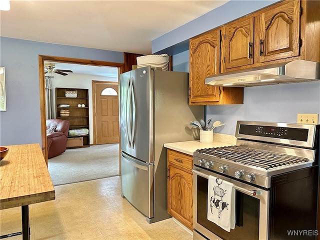 40 June Dr, Elma, NY 14059 - kitchen featuring appliances with stainless steel finishes, under cabinet range hood, ceiling fan, light countertops, and brown cabinetry