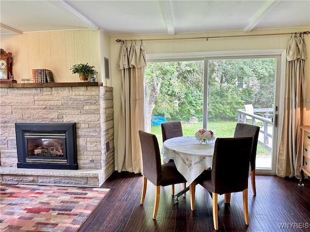 40 June Dr, Elma, NY 14059 - dining area featuring wood-type flooring, beamed ceiling, a fireplace, and wooden walls