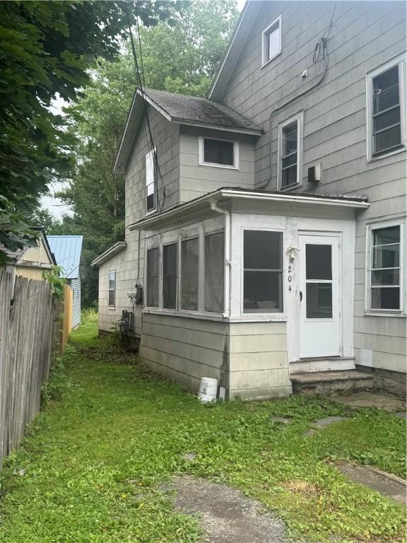 204 Owego St, Montour, NY 14865 - view of side of home featuring entry steps, a sunroom, and a shingled roof