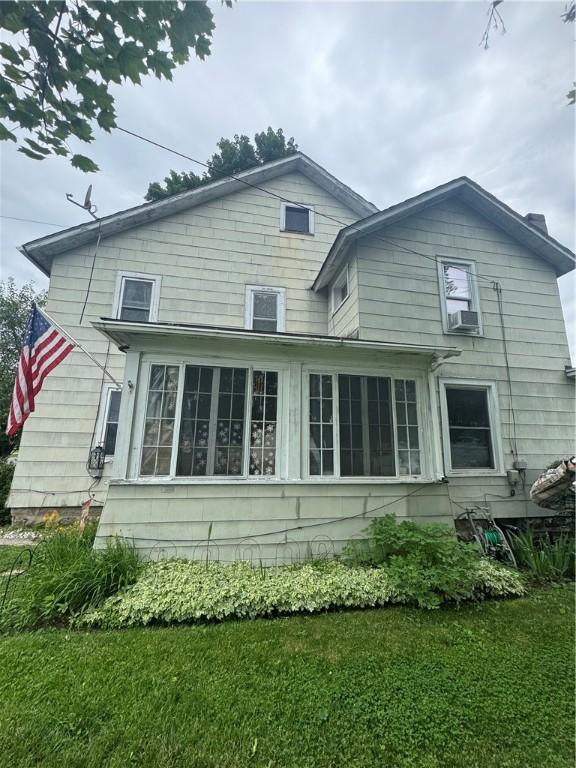 204 Owego St, Montour, NY 14865 - rear view of house with cooling unit, a sunroom, and a lawn