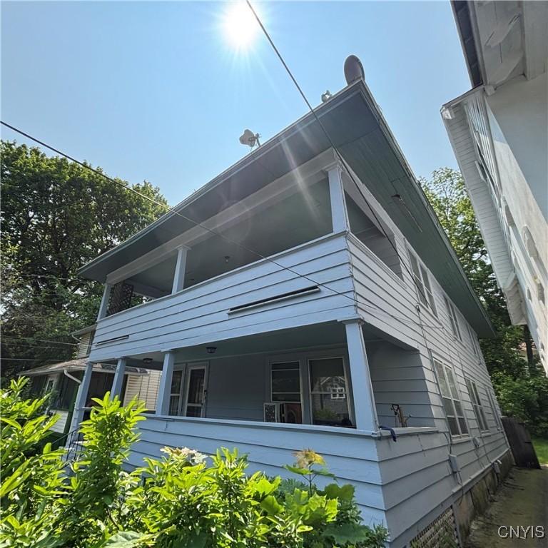 110 Bellaire Pl, Syracuse, NY 13207 - view of home's exterior with a balcony and a porch
