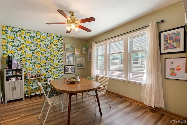 180 Lovering Ave, Buffalo, NY 14216 - dining space with a ceiling fan, light wood finished floors, an accent wall, and wallpapered walls