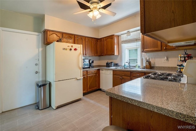 180 Lovering Ave, Buffalo, NY 14216 - kitchen featuring white appliances, brown cabinetry, and ceiling fan