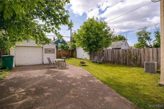 180 Lovering Ave, Buffalo, NY 14216 - view of patio / terrace with an outdoor structure, a detached garage, an outdoor fire pit, and driveway