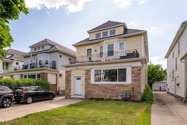 180 Lovering Ave, Buffalo, NY 14216 - traditional style home with stone siding, a balcony, and a front lawn