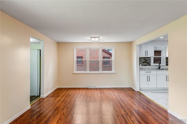 35 Kendale Rd, Cheektowaga, NY 14215 - unfurnished living room with wood finished floors and a textured ceiling