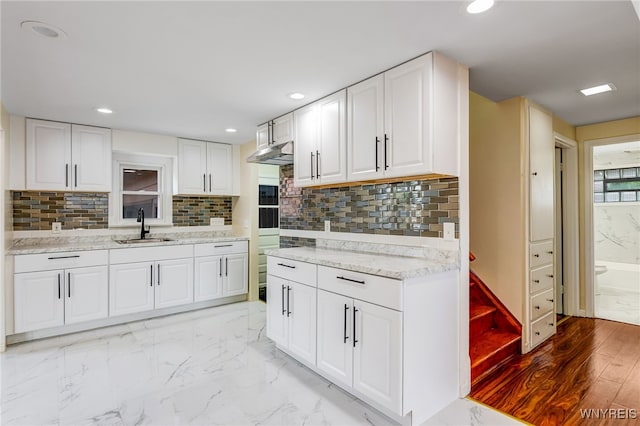 35 Kendale Rd, Cheektowaga, NY 14215 - kitchen with white cabinets, light marble finish flooring, decorative backsplash, and recessed lighting