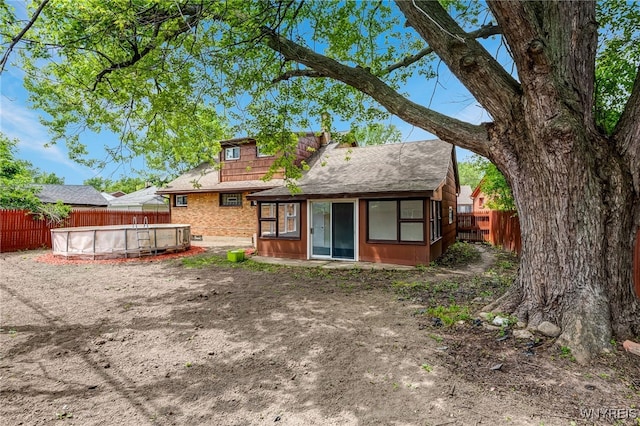 35 Kendale Rd, Cheektowaga, NY 14215 - back of property featuring a fenced backyard, brick siding, and a shingled roof