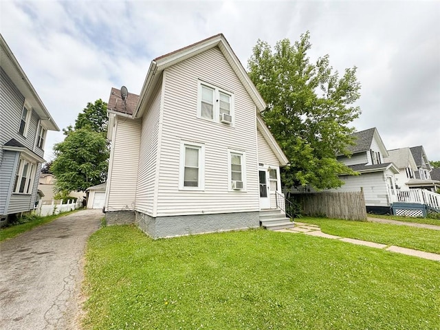 149 Post Ave, Rochester, NY 14619 - view of front facade featuring entry steps, cooling unit, an outdoor structure, and a detached garage