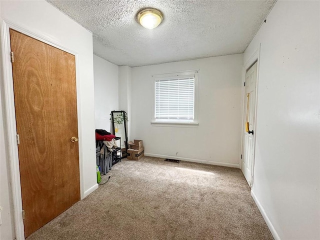 149 Post Ave, Rochester, NY 14619 - unfurnished bedroom featuring carpet and a textured ceiling