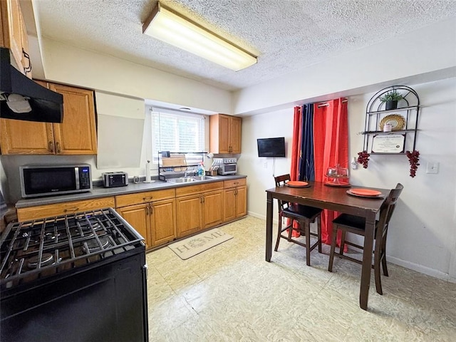 149 Post Ave, Rochester, NY 14619 - kitchen with stainless steel microwave, light floors, black range with gas stovetop, brown cabinets, and a textured ceiling