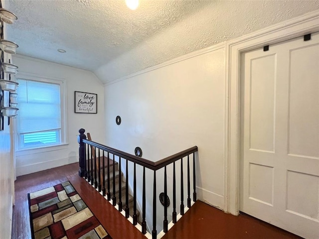 149 Post Ave, Rochester, NY 14619 - stairs with a textured ceiling, vaulted ceiling, and wood finished floors