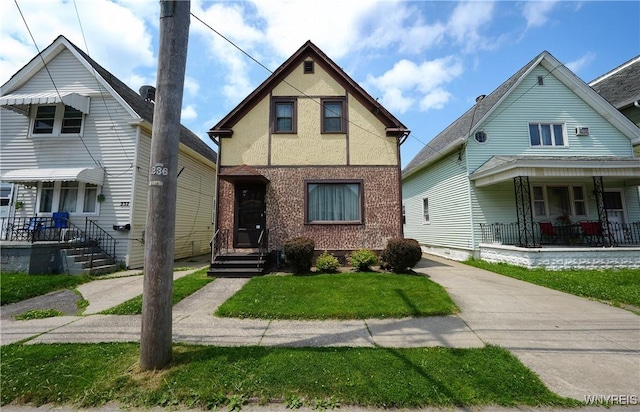 236 Weimar St, Buffalo, NY 14206 - view of front of house featuring covered porch, a front lawn, stucco siding, and driveway