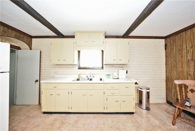236 Weimar St, Buffalo, NY 14206 - kitchen with light countertops, wood walls, cream cabinets, beamed ceiling, and freestanding refrigerator