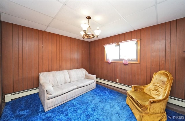 236 Weimar St, Buffalo, NY 14206 - sitting room featuring a baseboard radiator, carpet flooring, a paneled ceiling, a chandelier, and wooden walls