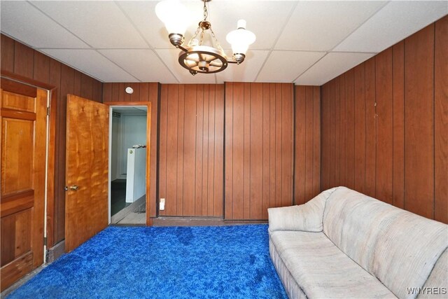 236 Weimar St, Buffalo, NY 14206 - living area featuring carpet, a drop ceiling, a chandelier, and wood walls