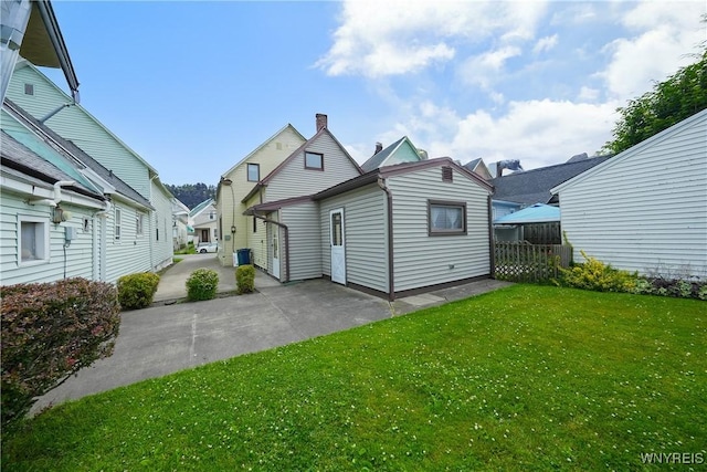 236 Weimar St, Buffalo, NY 14206 - rear view of house featuring a lawn and a patio