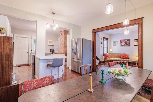 70 Field St, Rochester, NY 14620 - dining space with wood finished floors and a chandelier