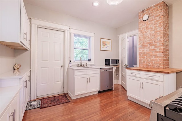 70 Field St, Rochester, NY 14620 - kitchen featuring stainless steel appliances, light wood finished floors, white cabinets, and butcher block countertops