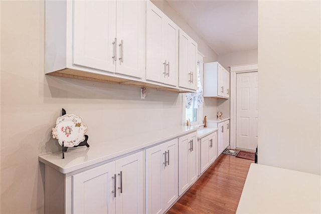 70 Field St, Rochester, NY 14620 - kitchen featuring light countertops, white cabinets, and wood finished floors