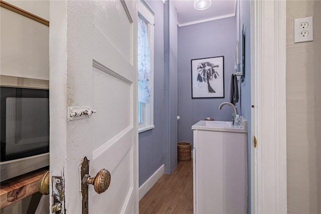 70 Field St, Rochester, NY 14620 - bathroom featuring wood finished floors, vanity, and ornamental molding