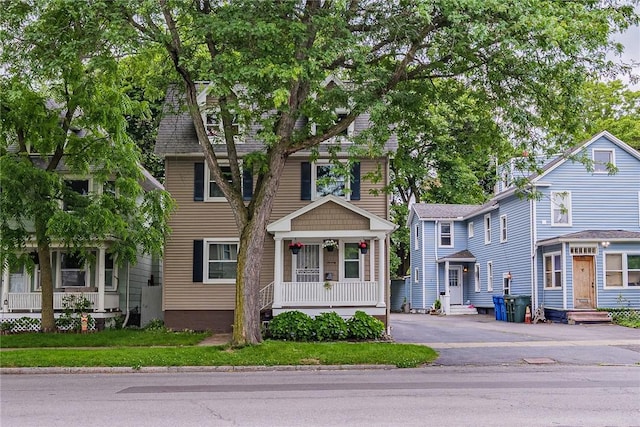 70 Field St, Rochester, NY 14620 - view of front of property featuring a porch, asphalt driveway, and entry steps