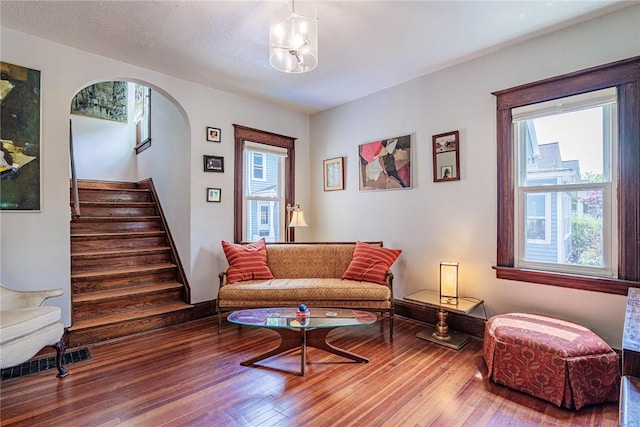 70 Field St, Rochester, NY 14620 - living area featuring hardwood / wood-style floors, stairway, and arched walkways
