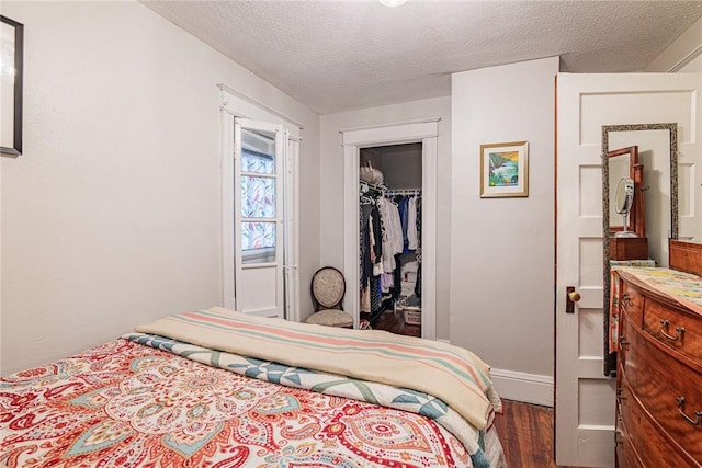 70 Field St, Rochester, NY 14620 - bedroom with wood finished floors, a closet, and a textured ceiling