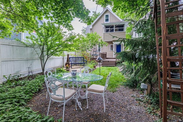 70 Field St, Rochester, NY 14620 - fenced backyard featuring a wooden deck and outdoor dining space