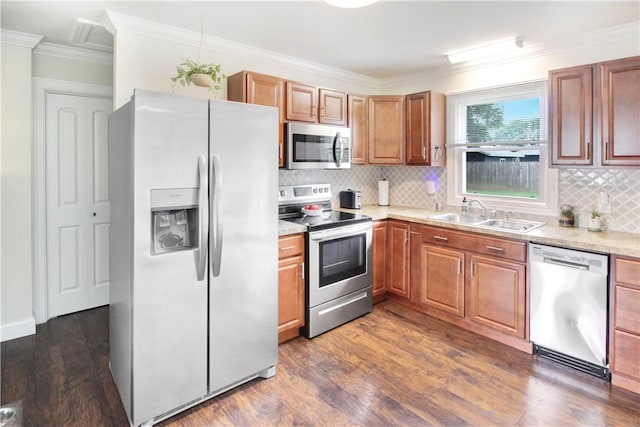 133 Berkley Ln, Horseheads, NY 14845 - kitchen featuring stainless steel appliances, dark wood finished floors, backsplash, light countertops, and ornamental molding