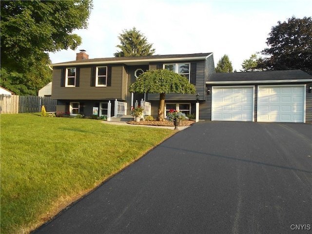 1003 Rondo Ave, Sullivan, NY 13037 - bi-level home featuring asphalt driveway, a chimney, and an attached garage