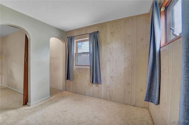 464 Rowley Rd, Cheektowaga, NY 14043 - spare room with carpet, arched walkways, and wooden walls