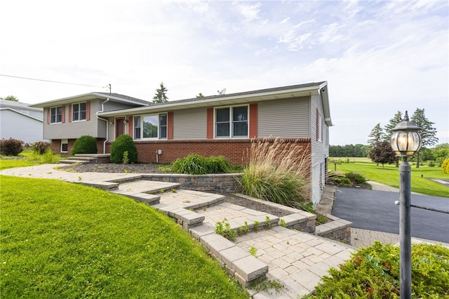 7175 Gale Rd, Lima, NY 14485 - tri-level home with a front yard and brick siding