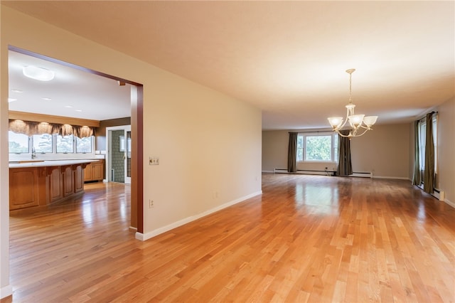7175 Gale Rd, Lima, NY 14485 - spare room featuring a chandelier, light wood-type flooring, a baseboard radiator, and baseboard heating