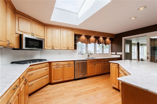 7175 Gale Rd, Lima, NY 14485 - kitchen featuring stainless steel appliances, a skylight, tasteful backsplash, light wood-style flooring, and recessed lighting